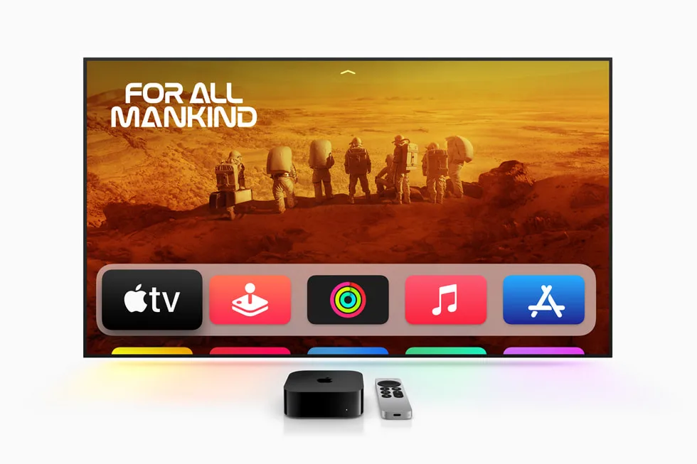 Apple TV 4K box and Siri Remote on a TV stand with a TV showing the iPlayTV IPTV channel guide, the complete Apple TV IPTV setup guide for Canada in 2026